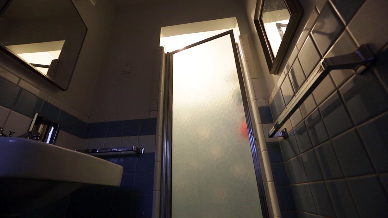 Still shot of a steamy shower in a dark bathroom, loopable, royalty free.