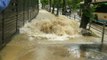 Water Surges Onto Pavement From Burst Pipe Following Japan Earthquake