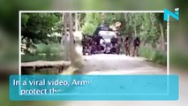 Army men make human shield to protect from stone-pelters