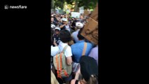 Philadelphia police officer seen striking at protester during rally against family separations