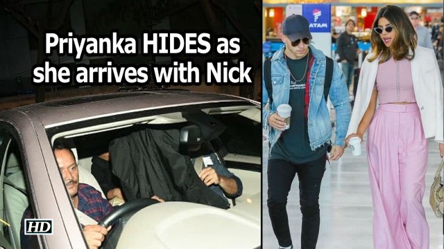Priyanka HIDES as she arrives with Nick Jonas