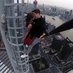 A girl & Boy having french kiss on the top of the Building