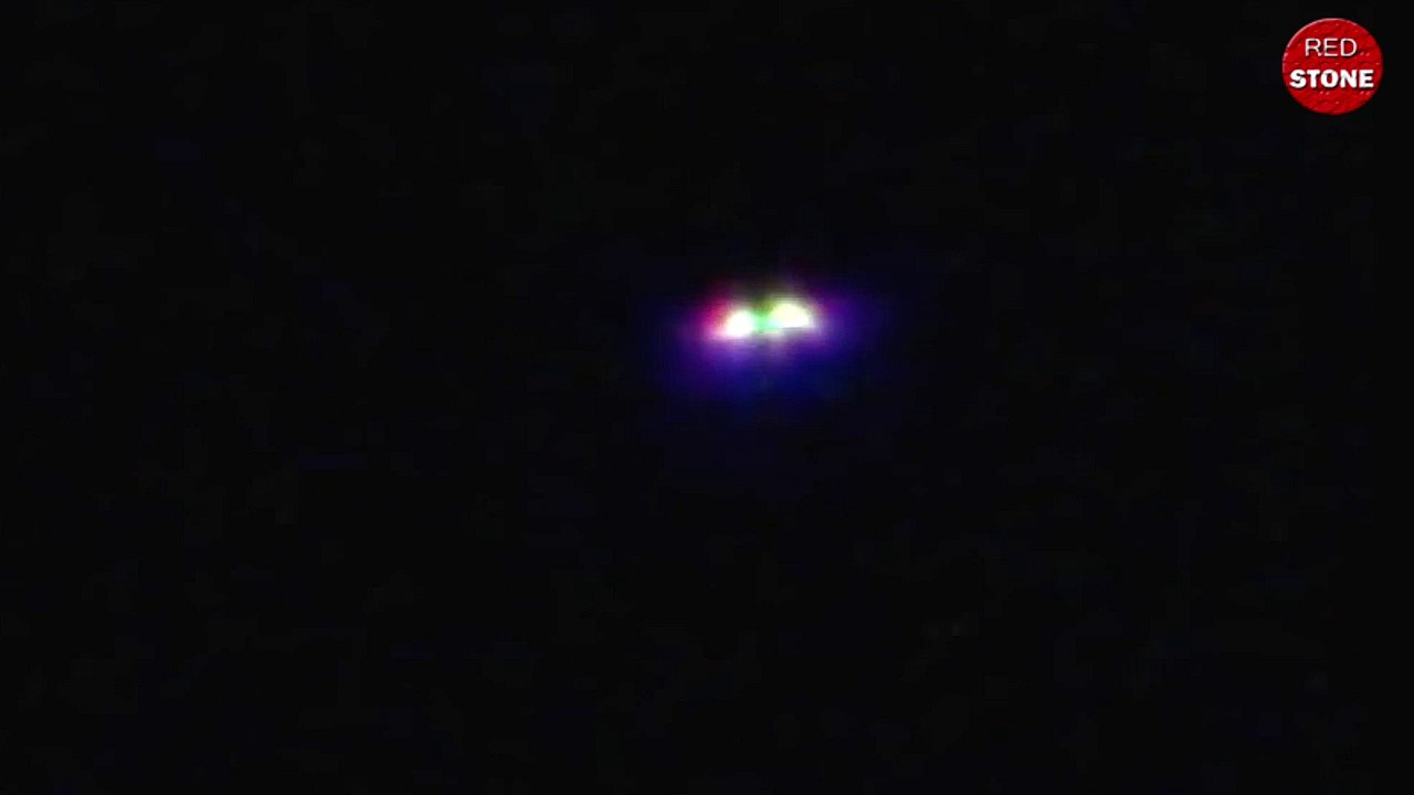 Extraterrestrial multi-colored UFO leaving to space into the sky in Texas