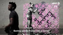 Banksy needles France on migrants with Paris mural blitz