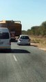 Car Attempts to Pass Truck on Narrow Road