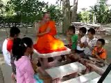 Buddhist Monk chanting with children