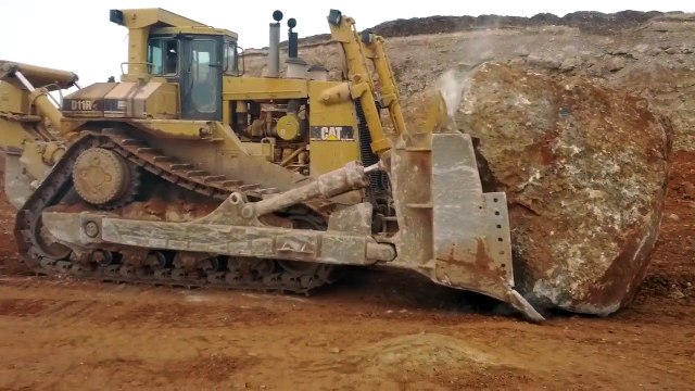 Caterpillar D11R pushing another massive rock