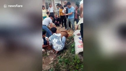 Boy trapped in concrete pipe is smashed out by his dad