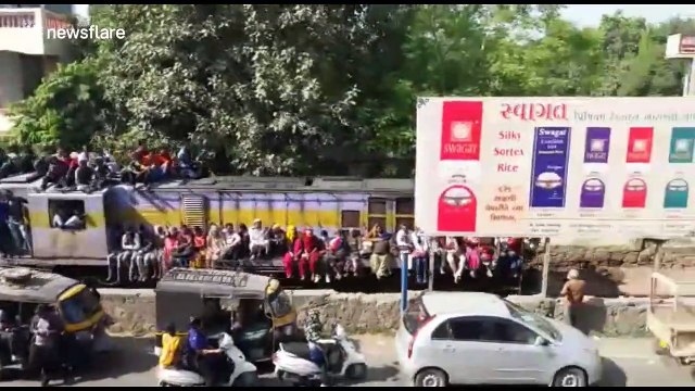 Indian pilgrims surf train in huge numbers en route to holy festival