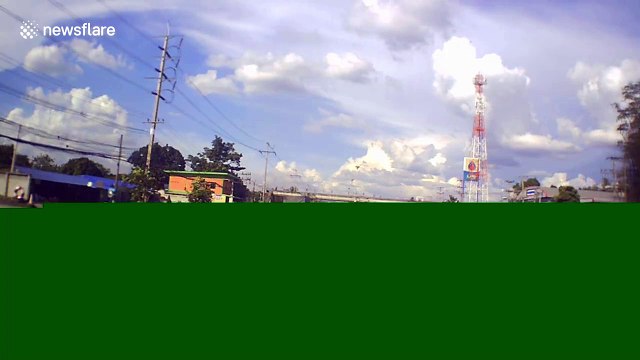 Terrifying moment concrete power post falls onto family's car in Thailand