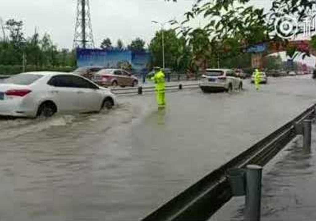 Chengdu Police Direct Traffic as Rain Floods Ci...