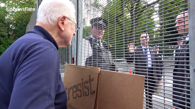 Protester holds ‘Dump Trump’ sign at president’s residence in London