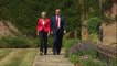 Theresa May and Donald Trump hold hands at Chequers