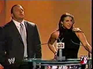 Triple HHH Stephanie Mcmahon receibing an award