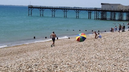 Man chases his parasol along Bognor beach