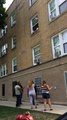 Toddlers Dangling out of Second Floor Window