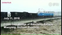Two fully loaded freight trains were parked on a bridge to keep the bridge stable in a flooded river on Wednesday in Mianyang, Sichuan Province. The flood rec