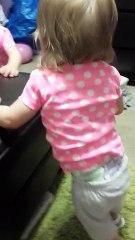 Baby girl adorably amused by squeaky shoes