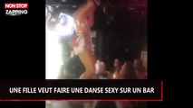 Une jeune femme veut faire une danse sexy sur un bar... (vidéo)