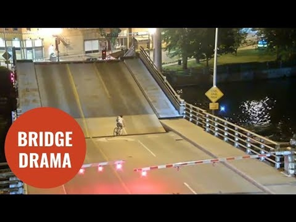 Cyclist ignores bridge warning barriers and falls into gap of drawbridge