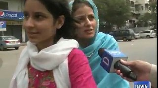 Daughter taking her mother to polling station on a motorbike in Karachi.