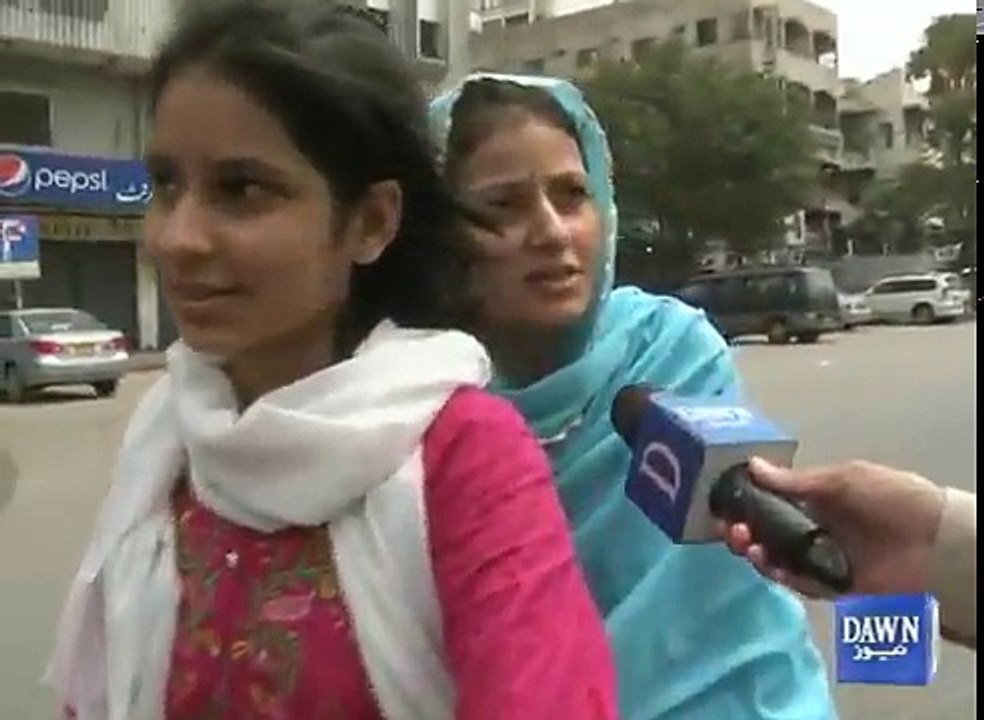 Daughter taking her mother to polling station on a motorbike in Karachi.