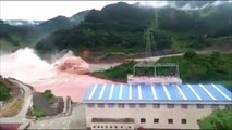 Water gushes over dam near scene of Laos flooding disaster