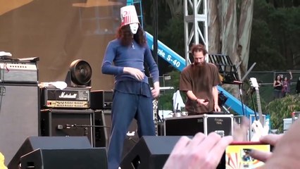 Buckethead playing with nunchucks and doing the robot on stage