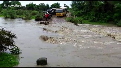 Reckless school bus driver speeds through flooded road in India