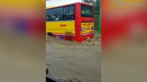 Bus Struggles Through Flooded Road