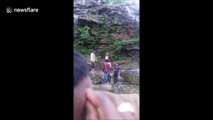 Shocking moment man plunges off 50-foot waterfall after trying to take selfie
