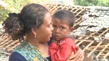 Indonesian villager digs out son barehanded from quake-collapsed house