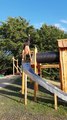 Guy Glides Down Slide While Performing Handstand