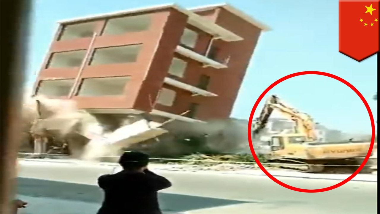 Demolition process goes wrong : building collapses on excavator