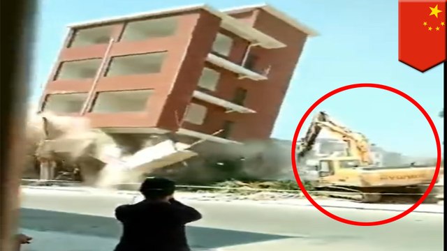 Demolition process goes wrong : building collapses on excavator