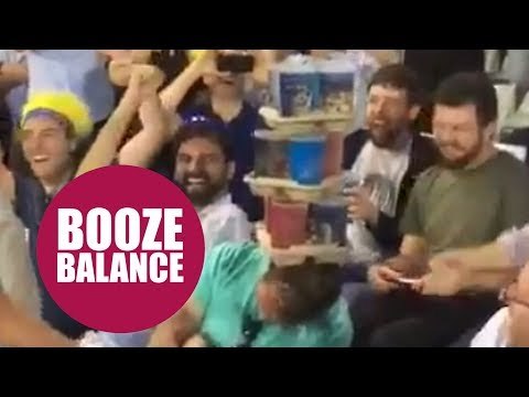 Hilarious moment cricket fans stack drinks on a sleeping fan