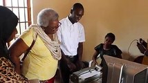 Mandela Washington Fellowship alumnus, Alieu Jaiteh, explains to Acting Public Affairs Officer Amelia Broderick how the braille machine works during the latter'