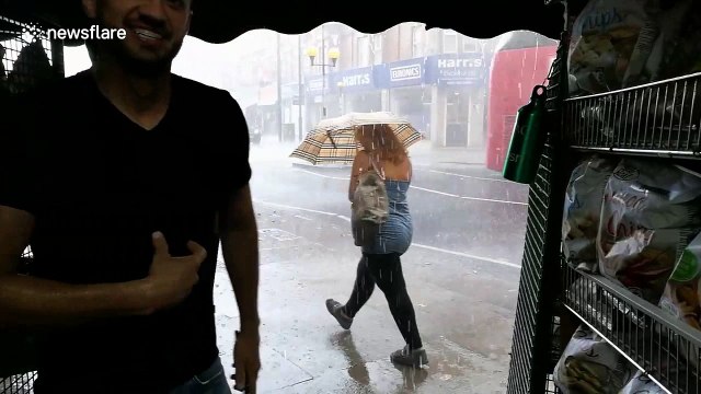 Torrential rain batters pedestrians in London