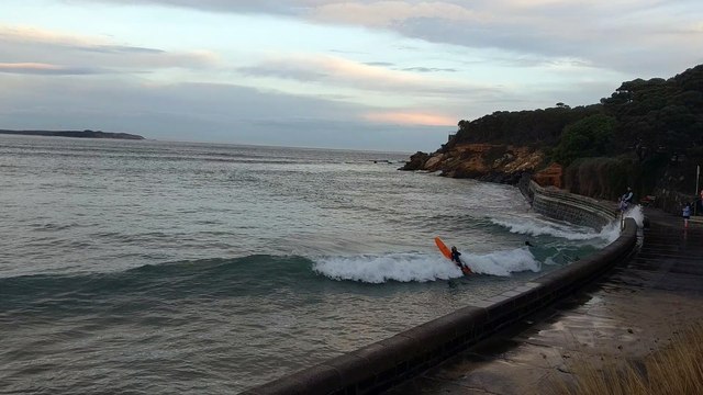 Kids Catch Waves Using Seawall