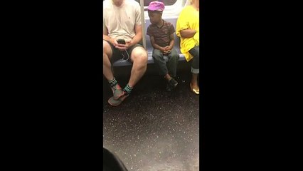 NYC subway rider shares his phone with a kid watching him play (Video)