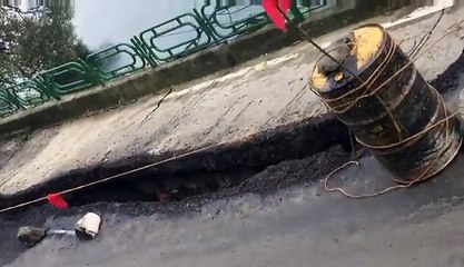 Sidewalk collapses into river