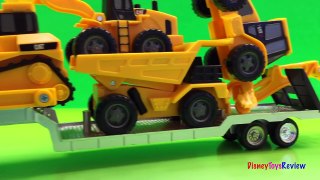 Transporter truck unloads the Mini Mighty Machines at the Construction Job Site Buldozer D