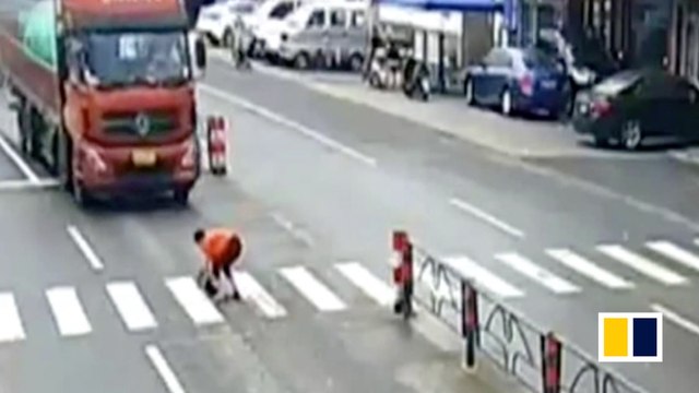 Chinese woman trying to save dog gets hit by truck