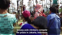 Men take part in traditional greasy pole contest at Asian Games