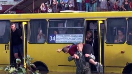 Firefighters save dozens from submerged bus in Ukraine