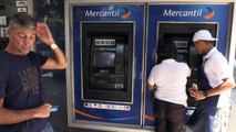 Venezuelans withdraw their first new banknotes from ATMs