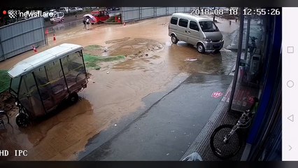 Two girls fall into pit covered by floodwater