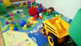 Toddlers Playing With Huge Toy Dump Truck and Plastic Colored Balls Caterpillar Toys Playt