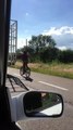 Bicycle Rider Holds onto Truck Tailgate