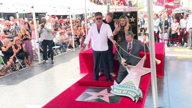 British music mogul Simon Cowell unveils Hollywood star